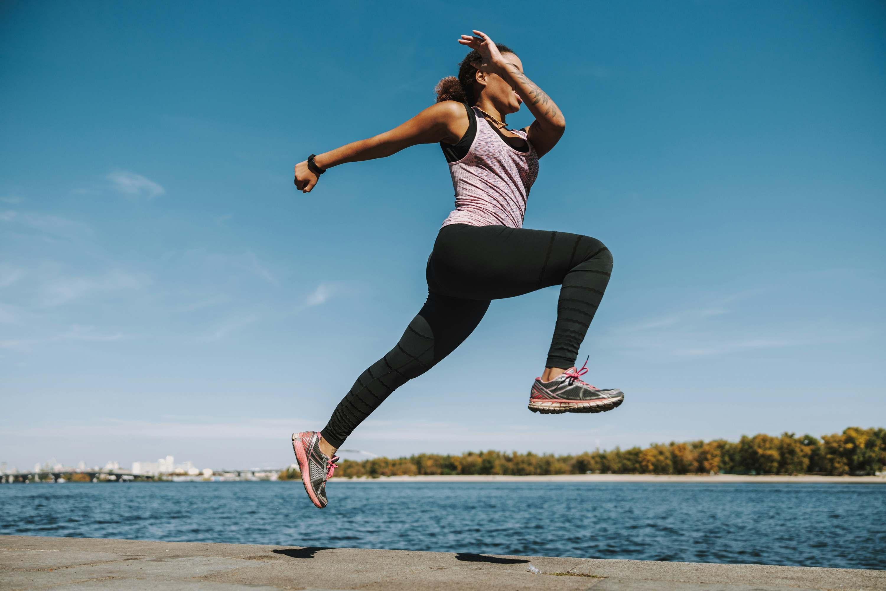 Athlete jumping at the waterfront