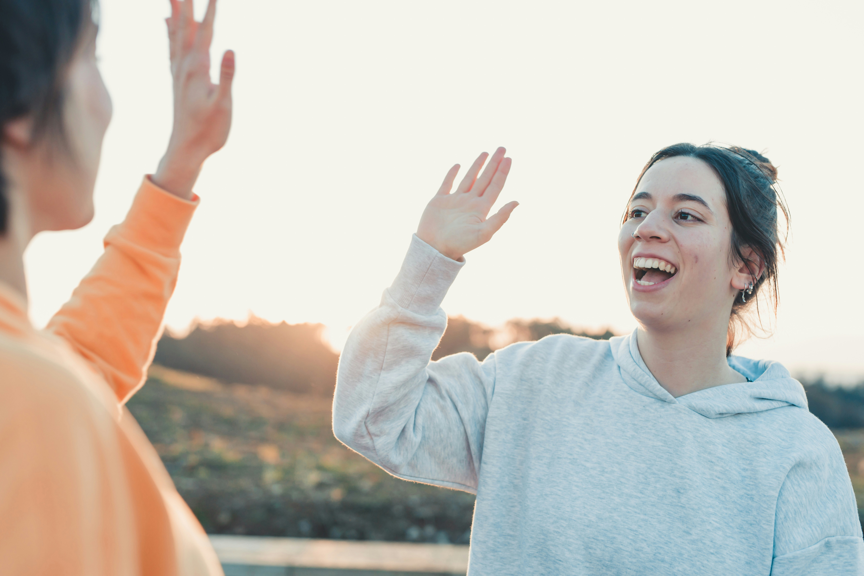 Two women high-fiving in a supportive moment